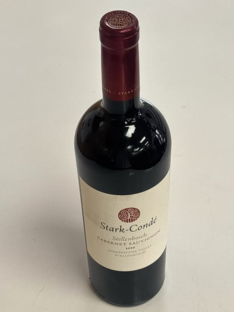 Bottle of Stark-Condé Stellenbosch Cabernet Sauvignon wine with burgundy foil cap and cream label