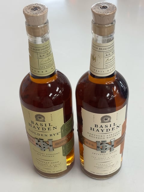 Two bottles of Basil Hayden Kentucky straight bourbon whiskey side by side